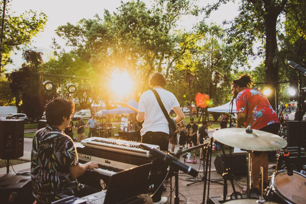 Live band performing outdoors at a community festival in the park